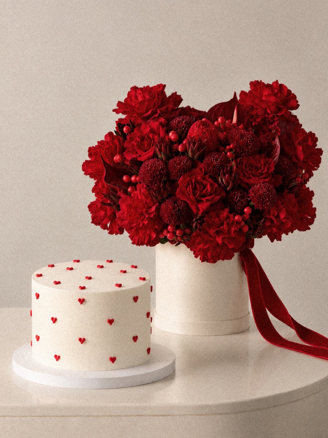Celebration cake with red hearts, shown with red flowers in a hat box, Maison Bloom Bali