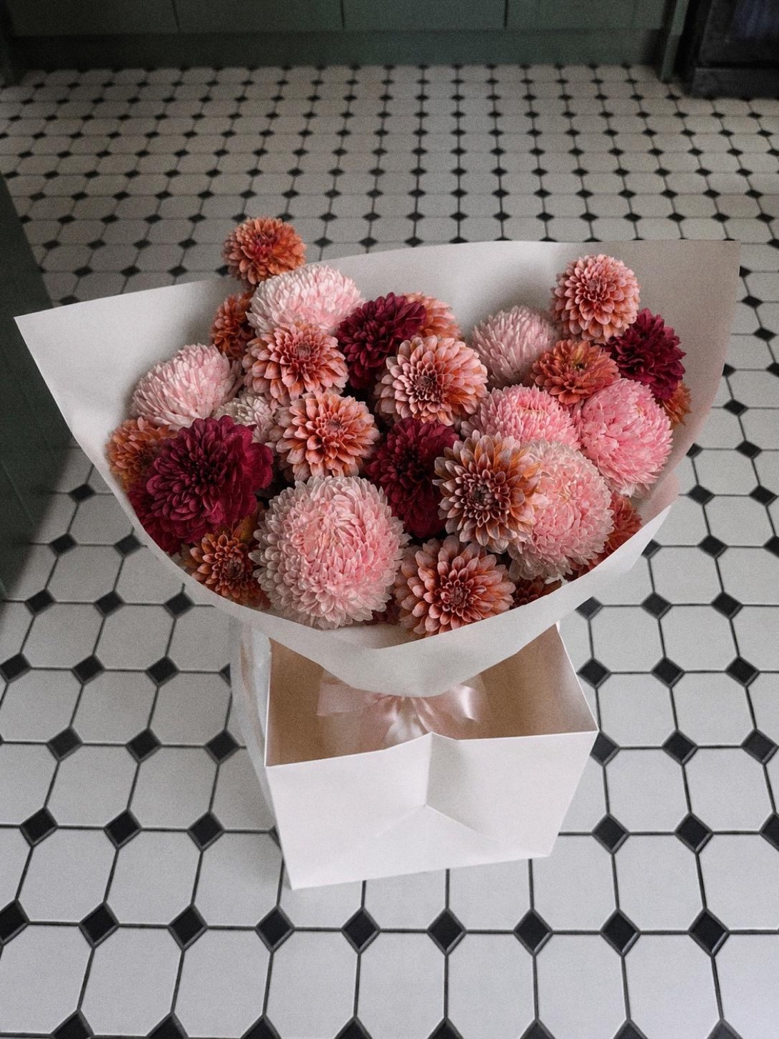 The Legian &mdash; pink and burgundy dahlia bouquet in a gift bag by Maison Bloom, Bali