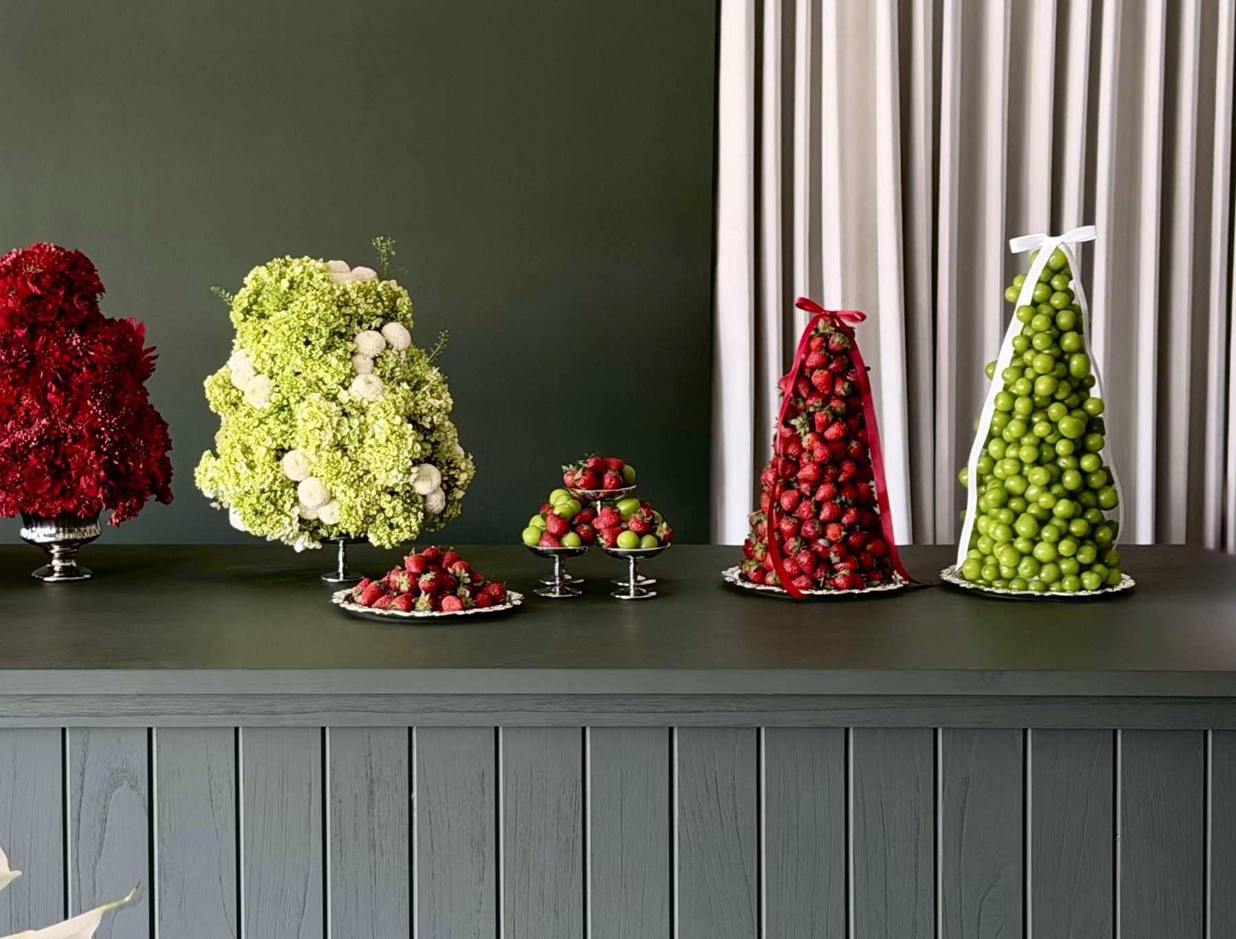 Strawberry and grape towers styled with floral arrangements at an event by Maison Bloom, Bali